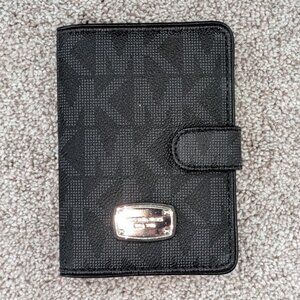Michael Kors small wallet, Black with silver accents. Slots inside.